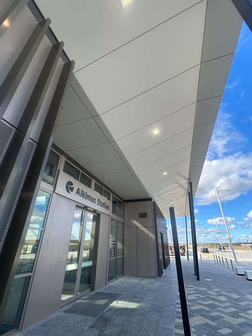 Station entry with cladded soffit above the automatic doors.