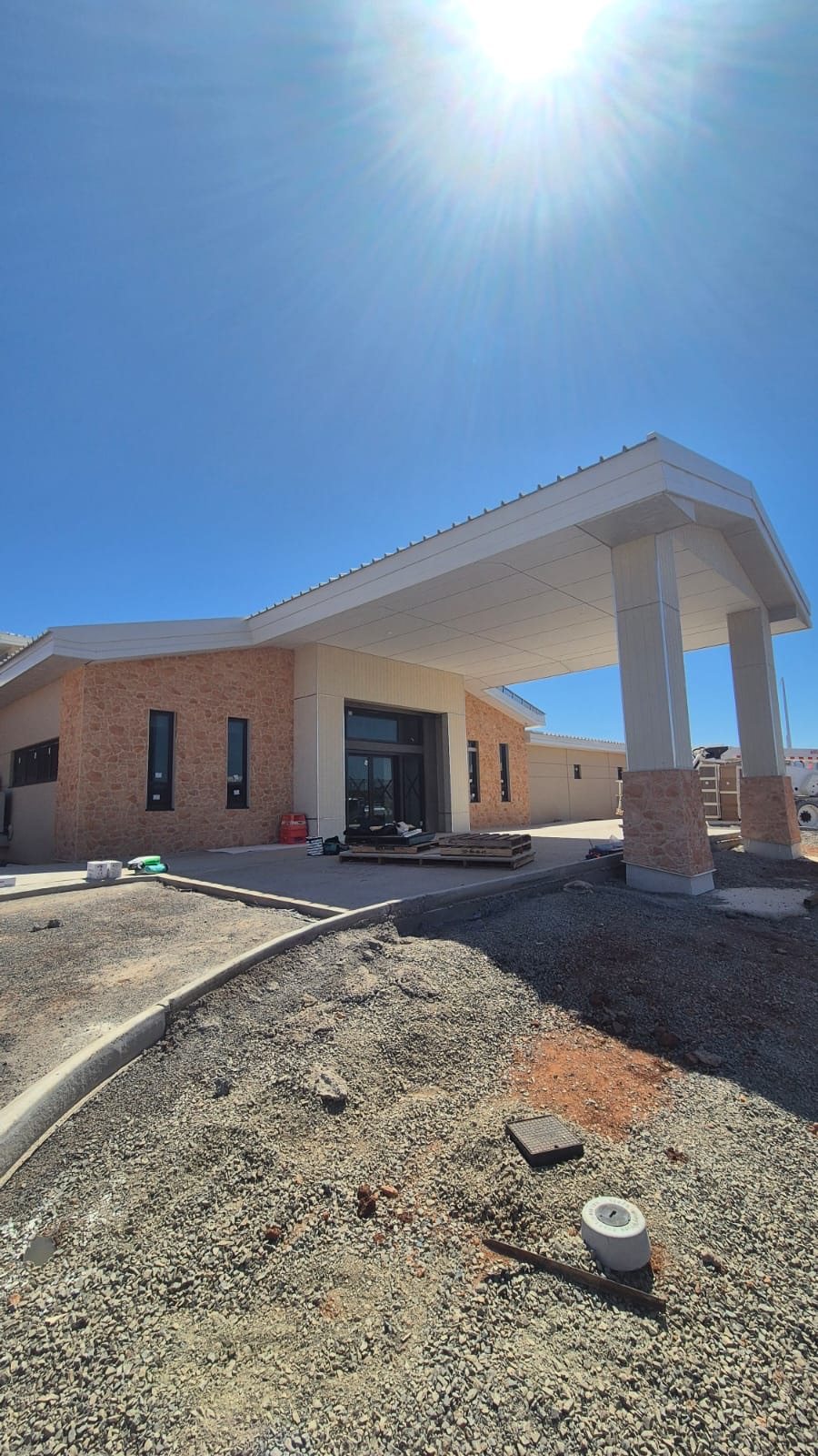 Clubhouse entry from the car park, CFC canopy soffit and clad columns completed.