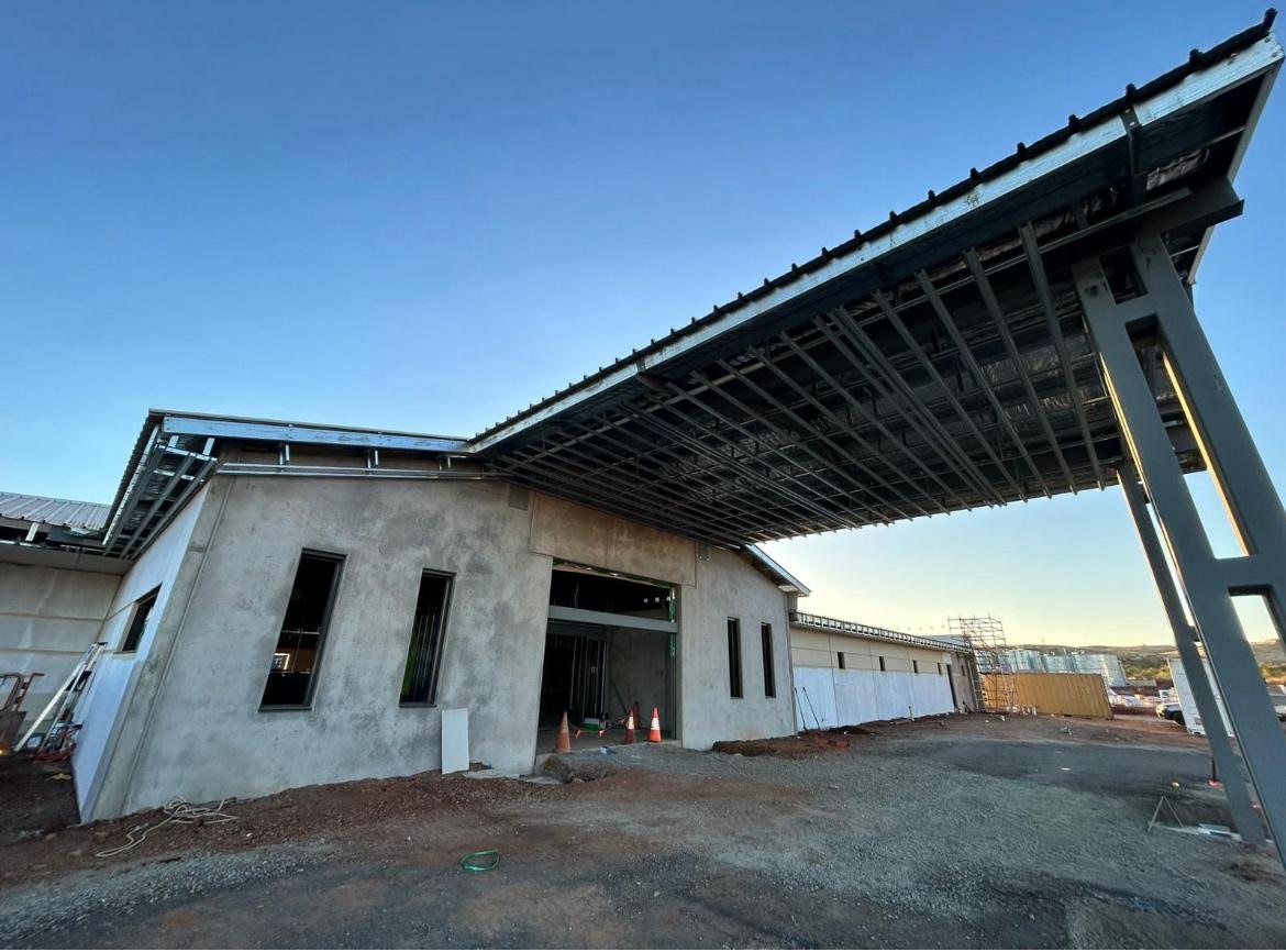 Canopy framing and building shell at an earlier stage, looking along the entry.