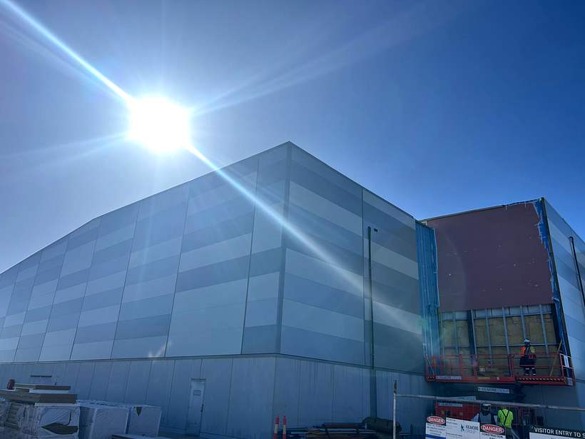 Completed banded panel elevation with the adjacent bay still being clad.