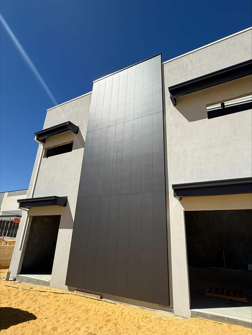 Cladding to the corner and reveals of a factory unit.
