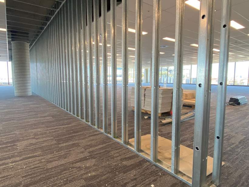 Steel stud partition framing set out across an office floor.