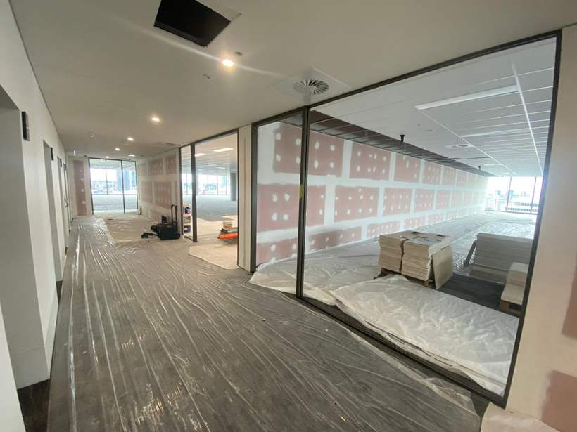 Office corridor with flushed partitions and floor protection down.