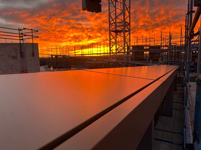 Halo element at sunset with the site crane behind.